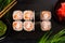 Set of sushi rolls with wasabi and ginger on black background. Japanese oriental cuisine