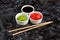 Set for sushi soy sauce ginger wasabi with chopstick on stone background