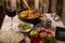 A set table for the Passover Seder with traditional matzah, wine, maror and a hot cholent for the meal and menorah.