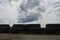 Set of tanks with oil and fuel transport by rail under cloudy sky