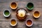 Set for tea ceremony. Glass teapot and ceramic cups on dark wooden background top view