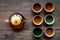 Set for tea ceremony. Glass teapot and ceramic cups on dark wooden background top view