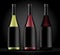 Set of three bottles of wine on a dark background