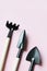 set of three garden tools on pink background