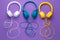 Set of three headphones over purple background. Music concept.