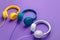 Set of three headphones over purple background. Music concept.