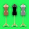 Set of three mannequins fashion of different colors on a gold pillars