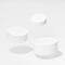 Set of three round tilt white pedestals for cosmetic products mockup, fly in hard light, shadow on white background.