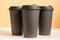 Set of three takeaway black coffee cup on neutral background natural light. Mock -up, nobody, front view