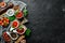 A set of tomato sauces on a black stone background. Ketchup, barbecue sauce, tomato sauce. Top view.