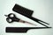 A set of tools for a hairdresser. Black scissors and a comb