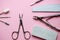 Set of tools for manicure and mail design on a pink background