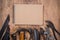 Set of tools and notebook for shoemaker on a wooden background.