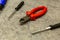 Set of tools a pair of black screwdrivers bright red nippers repair equipment