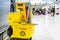 A set of tools and plates for mopping at the airport. Yellow bucket plates and brushes. Cleaning Service