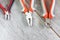 Set of two different types of pliers, side knives and fasteners on a gray laminate. Image on the theme of repair, decoration,