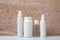 Set of unbranded beauty products for skincare on white table against marble background