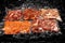 Set of vacuum-packed different meats,on dark ice background.Semifinished