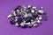 Set of various amethyst natural mineral stones and gemstones on purple background