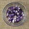 Set of various amethyst natural mineral stones and gemstones on rough linen Narrow focus line, shallow depth of field