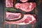 Set of various classic, alternative raw meat, veal beef steaks, dry aged, tomahawk, t bone or porterhouse and club steak, on old