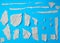 Set of various pieces of torn gray crumpled paper on a blue background