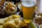 Set of various snacks, pint of lager beer in a glass, a standard set of drinking and eating in a pub