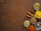 Set of various spices on a dark brown rusty metal table - coriander seeds, ground red pepper, salt, black