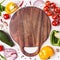 Set of vegetables and herbs around wooden cutting board. Social media or blog background