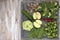 Set of vegetables on white painted plate and wooden background: kohlrabi, cucumber, apple, pepper, brussels sprouts, pea pods, bro