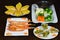 Set of Vietnamese food with grilled tiger shrimps, Barbecue geoduck with onion and grease, butter bread slides and boiled vegetabl