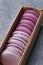 Set of violet and lilac macarons in cardboard gift box