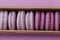 Set of violet and lilac macarons in cardboard gift box