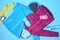 Set of warm sports clothes on color background, flat lay.