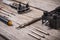 Set of watchmaker tools on a rough wooden board