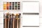 Set of watercolor paints, paintbrushes for painting and open notebook