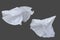 Set of white fluttering silk textile over dark gray background