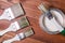 A set of white paint brushes, a metal can with white paint on a wooden texture table