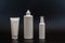 Set of white plastic bottles packages, tubes on black background. For cosmetic product.