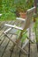 A set of wooden and lightly weathered patio furniture on a terrace