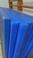 A set of worn royal blue gymnastics mats