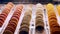 Sets of Colorful Sweet French Macaron Cakes in Row on the Cafe Display