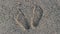 setting footprints on beach sand, painting feet on beach sand in a beautiful morning