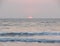 Setting Red Sun at Horizon over Sea at Payyambalam Beach, Kannur, Kerala, India