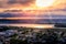 Setting sun breaking through flaming clouds over Auckland Harbour