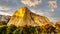 Setting Sun casting glowing sunlight over the famous El Capitan granite rock in Yosemite National Park