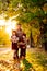 Setting sun. dad with daughters walking in autumn Park. happy family