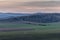 Setting sun on the left side and view of the countryside and surrounding nature panoramic view of the surrounding hills and