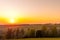 The setting sun over the forested mountain landscape of the Beskydy region, the sun sets beyond the horizon