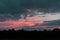 The setting sun silhouettes hills as it reflects upon the waters of the Ohio River as seen from Paden City, West